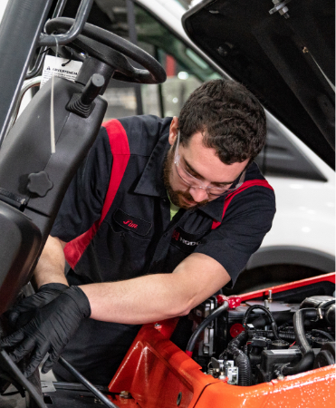 Service technician working on a forklift